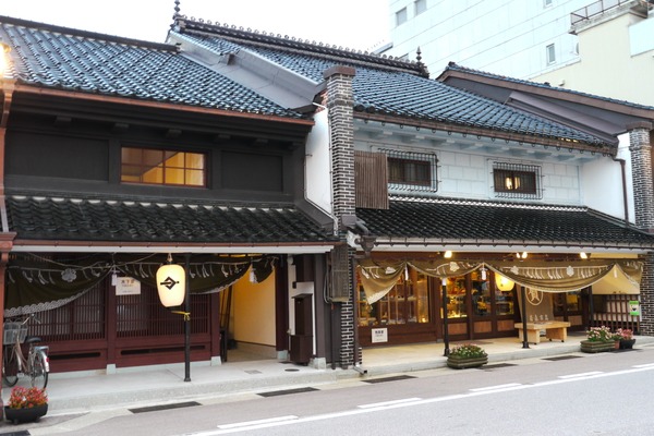 粋な玄関幕で飾られた土蔵造りの家